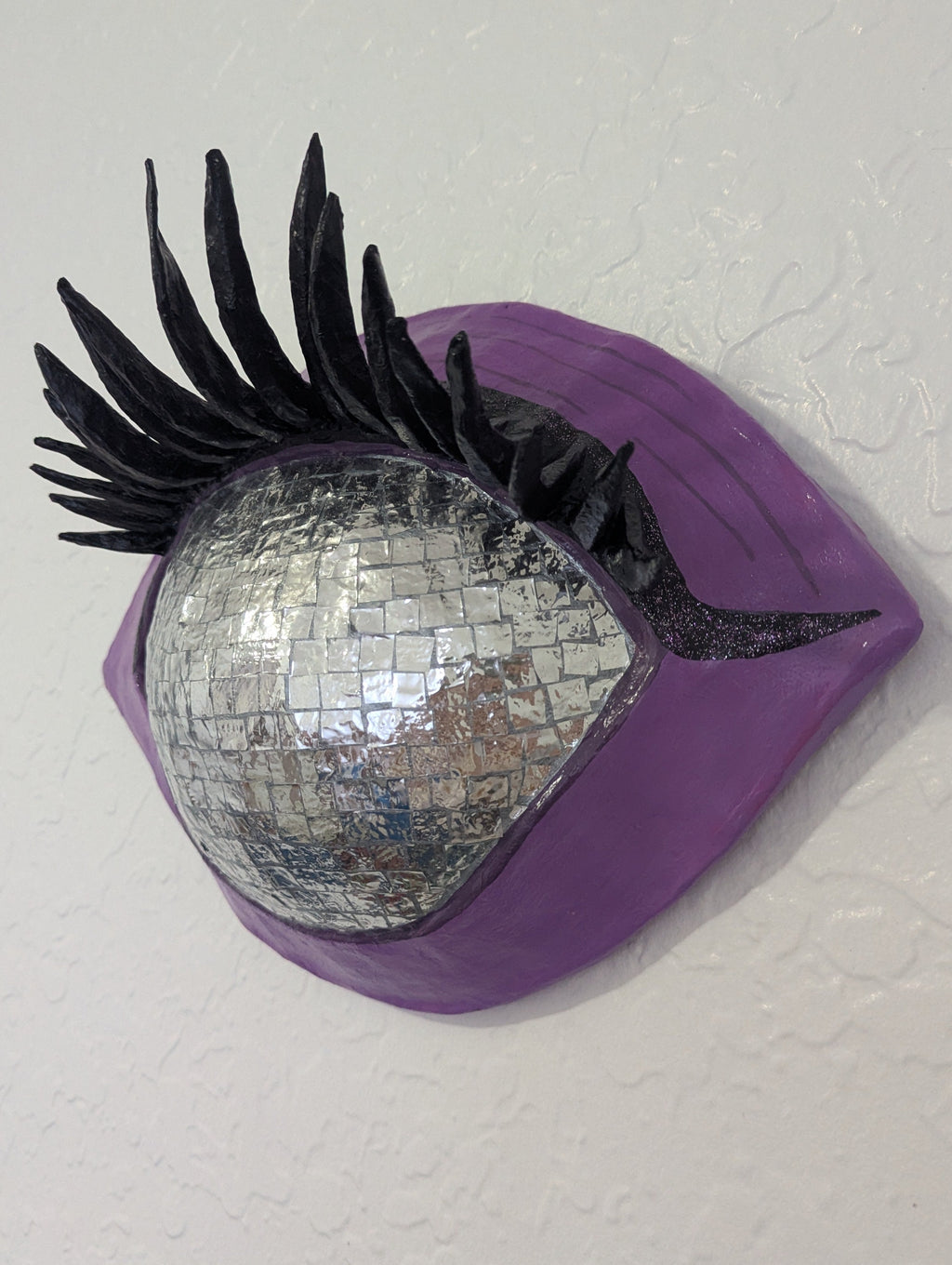 Dreamer's Eye disco ball eye sculpture angled view